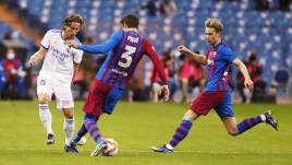 Real Madrids Luca Modric im Clasico gegen Barcelonas Gerard Piqué und Frenkie de Jong (12.01.2022)